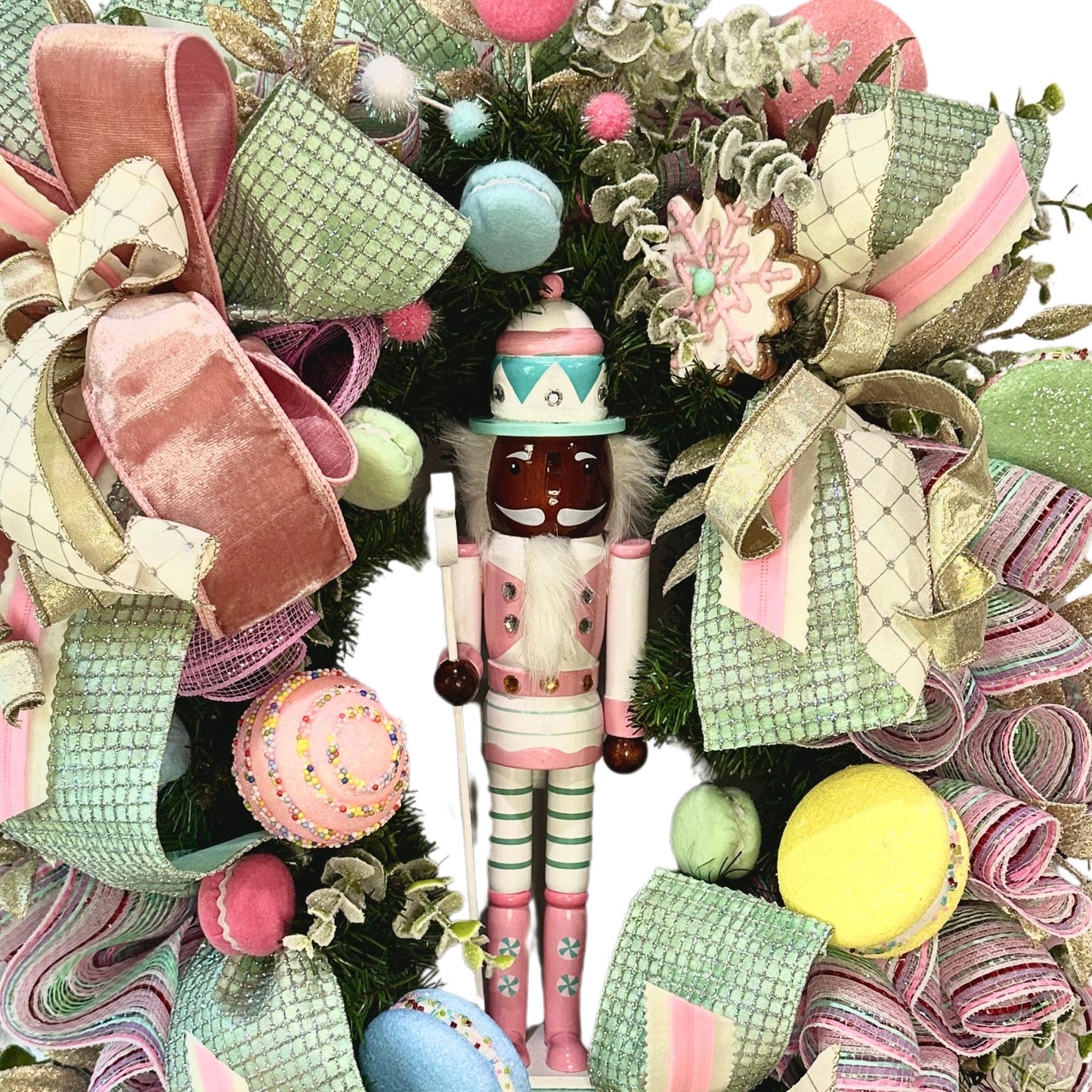 Candyland themed pink and mint green nutcracker Christmas wreath in pastel colors with dark face or light face soldier and sweet treats
