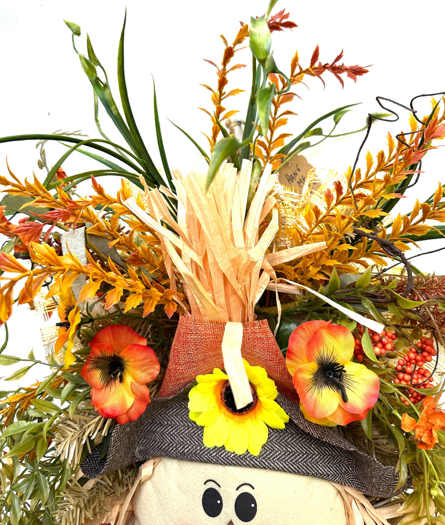 A Fall Large Smiling Scarecrow Wreath with Autumn Foliage and Festive Ribbons is the perfect Harvest, Thanksgiving or Halloween Decor