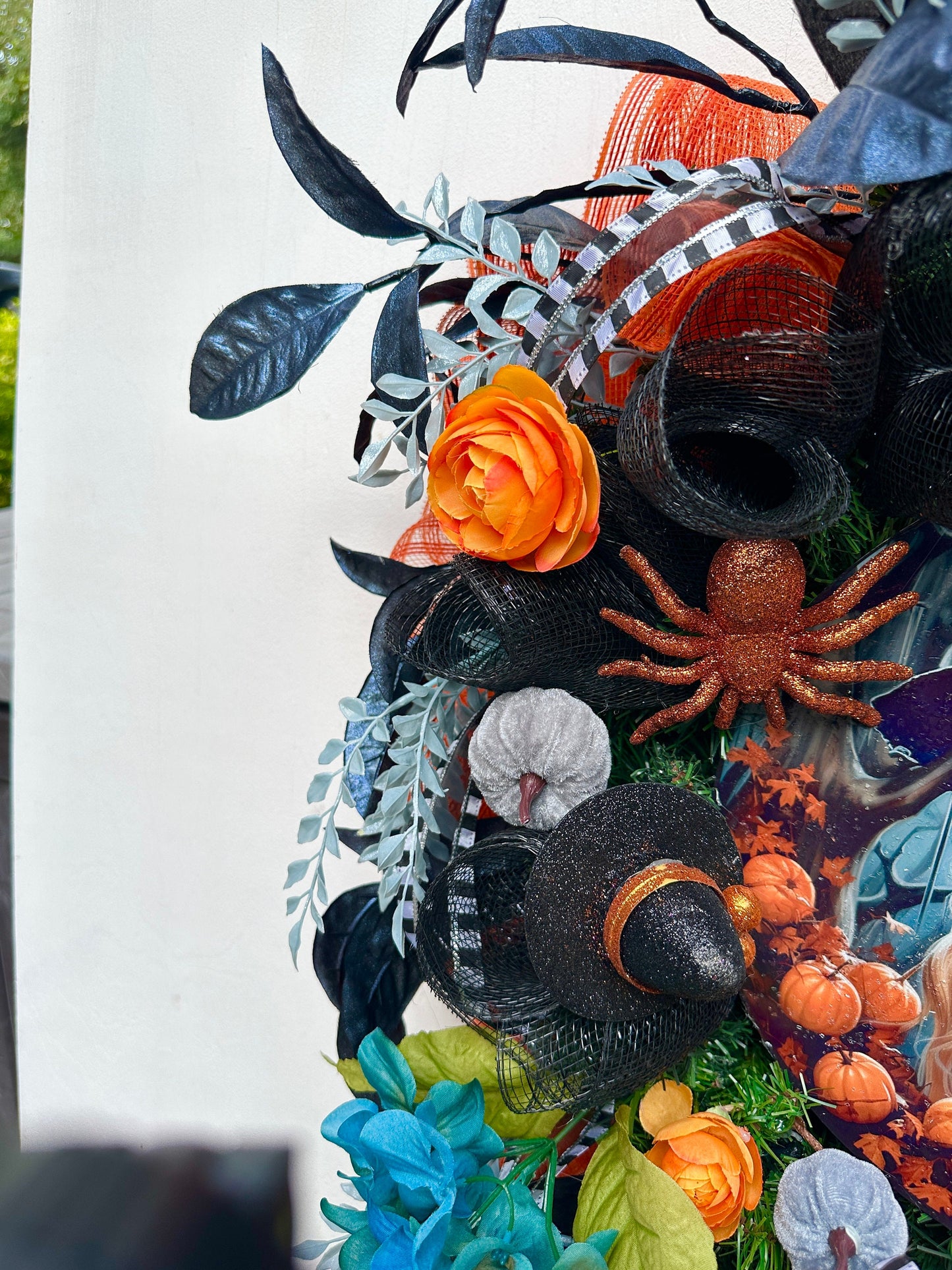 Wreath with glam witch sign, pumpkins, spider, witch hats and blue leaves gives a dark and moody Halloween vibe and add magic to your door.