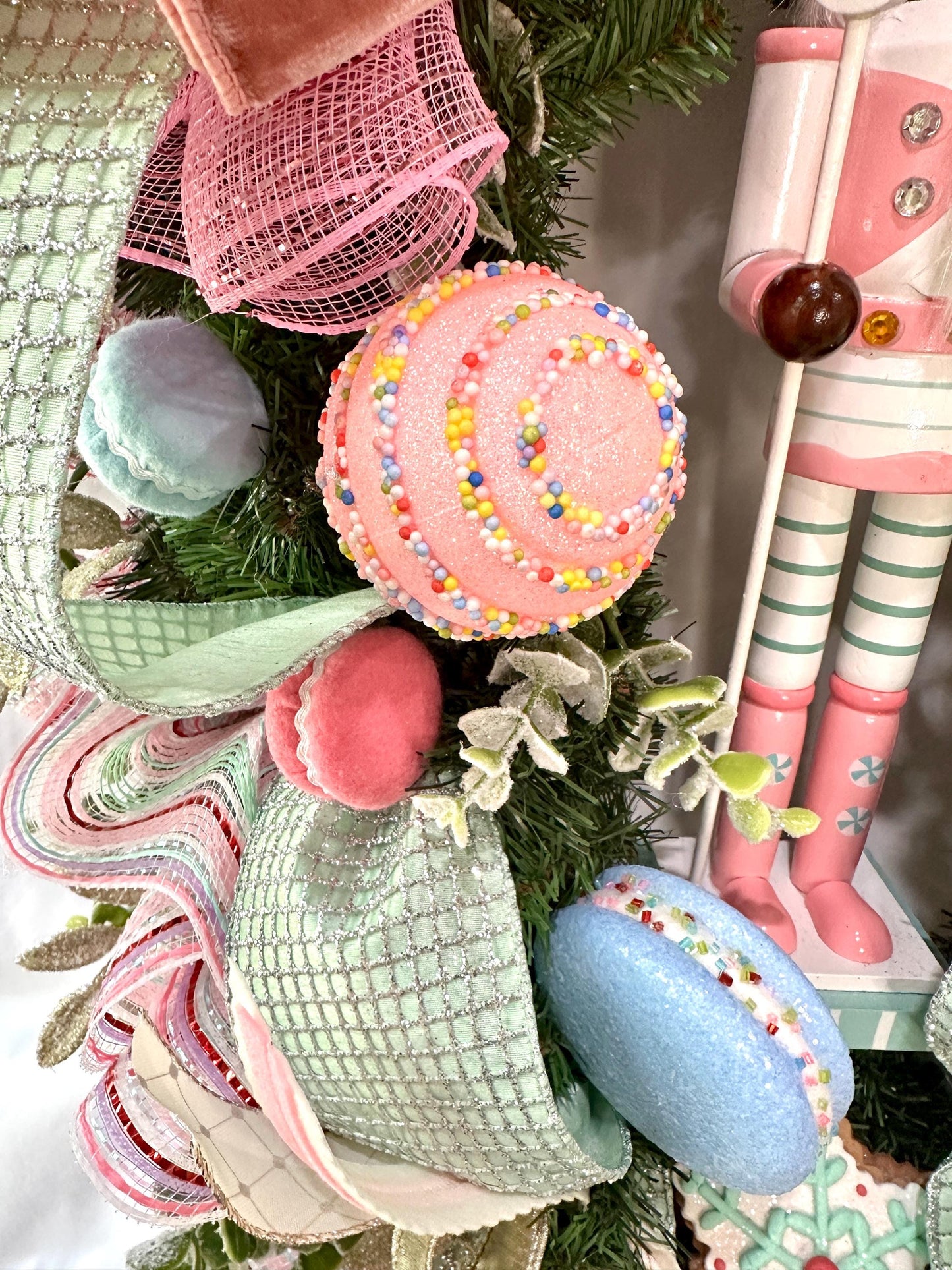 Candyland themed pink and mint green nutcracker Christmas wreath in pastel colors with dark face or light face soldier and sweet treats