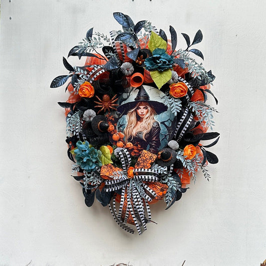 Wreath with glam witch sign, pumpkins, spider, witch hats and blue leaves gives a dark and moody Halloween vibe and add magic to your door.