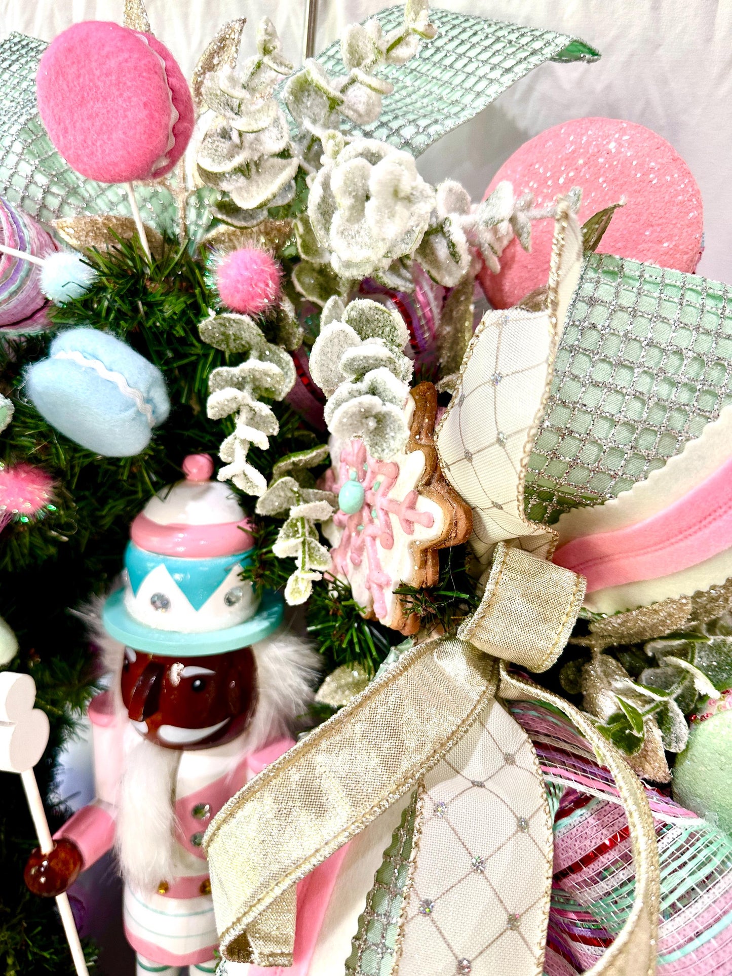 Candyland themed pink and mint green nutcracker Christmas wreath in pastel colors with dark face or light face soldier and sweet treats