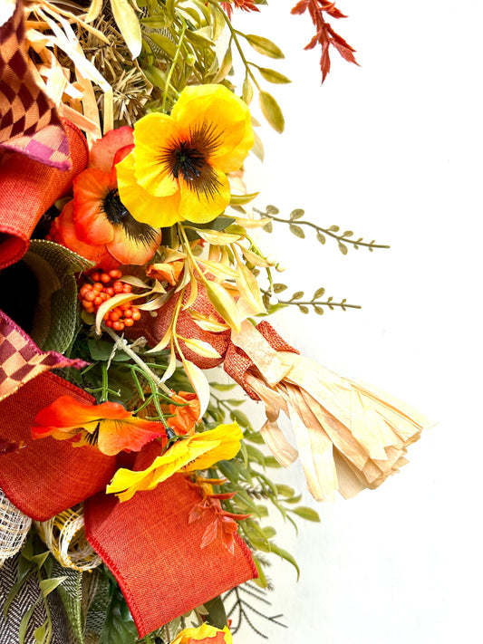 A Fall Large Smiling Scarecrow Wreath with Autumn Foliage and Festive Ribbons is the perfect Harvest, Thanksgiving or Halloween Decor