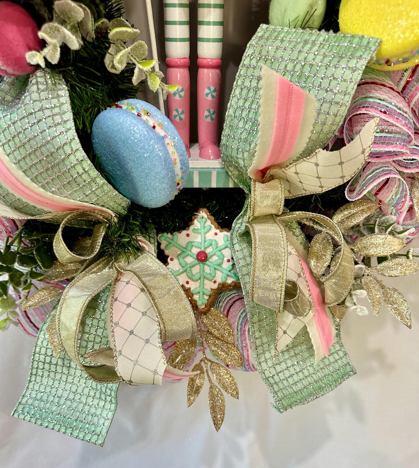 Candyland themed pink and mint green nutcracker Christmas wreath in pastel colors with dark face or light face soldier and sweet treats
