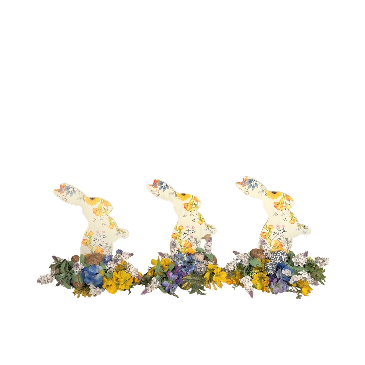 Set of 3 Wooden Standing Painted Easter Bunnies embellished with Blue, Yellow, and Lavender Flowers and Greenery for Easy Holiday Decor.