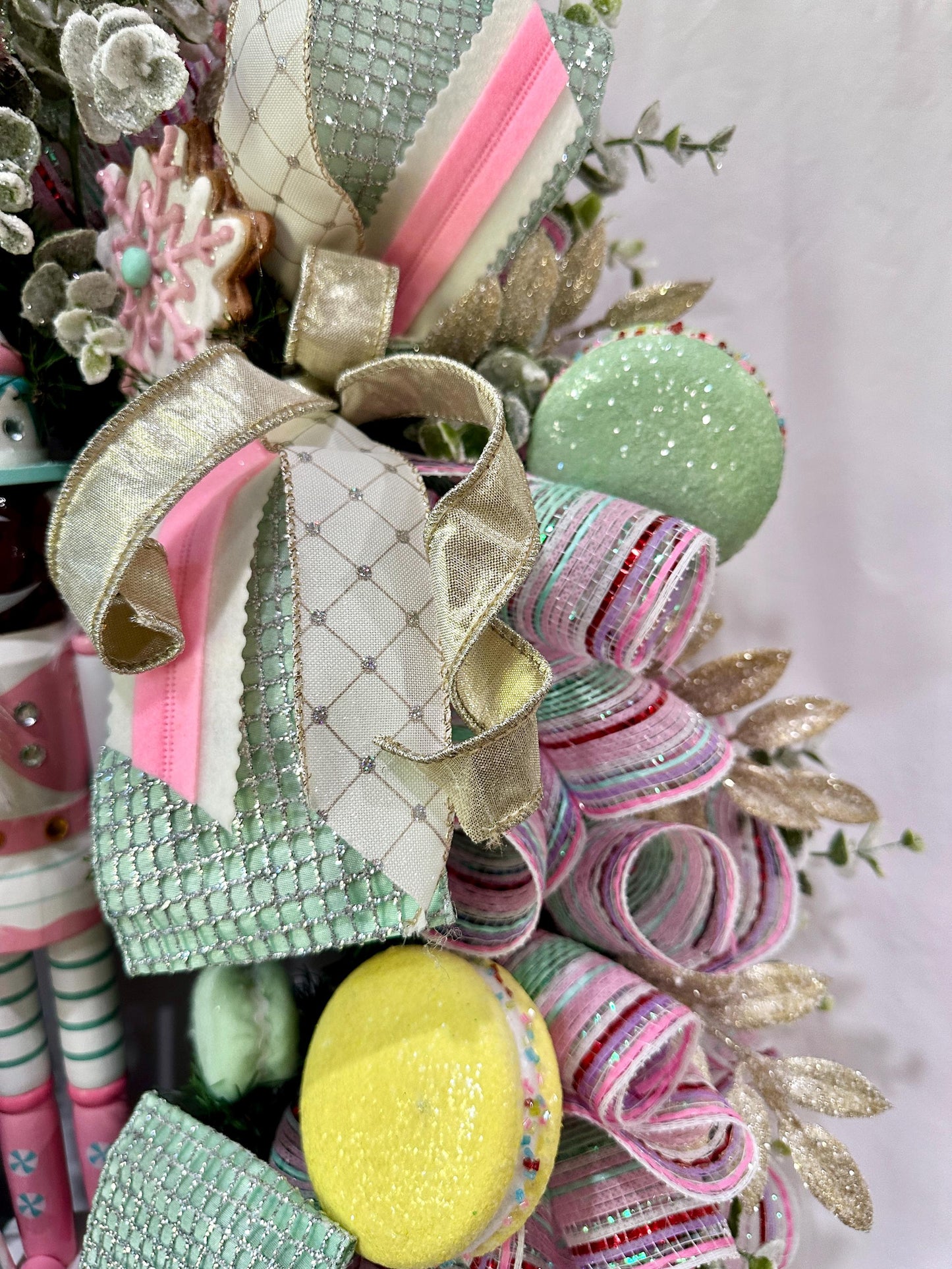 Candyland themed pink and mint green nutcracker Christmas wreath in pastel colors with dark face or light face soldier and sweet treats