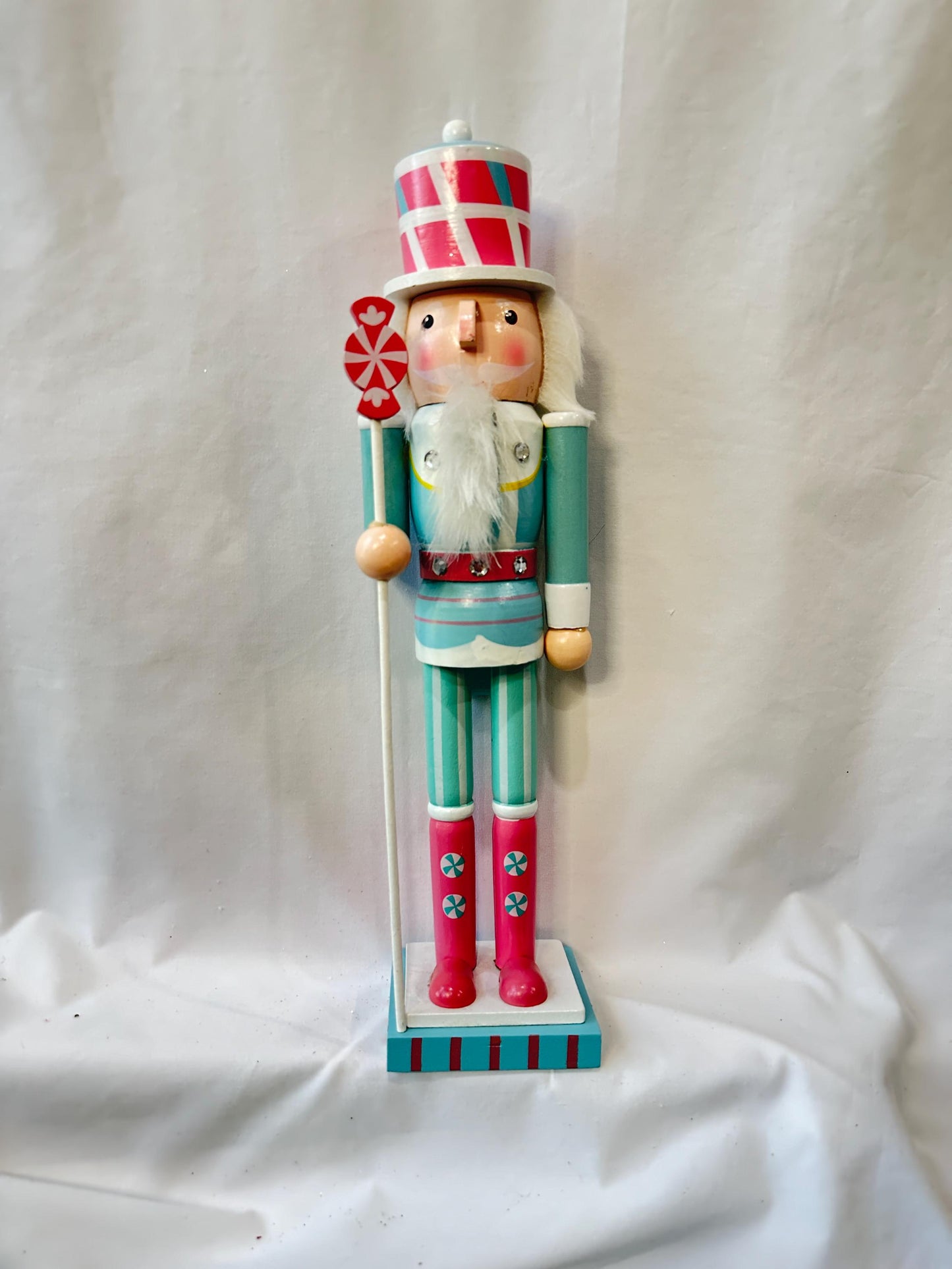 Candyland themed pink and mint green nutcracker Christmas wreath in pastel colors with dark face or light face soldier and sweet treats