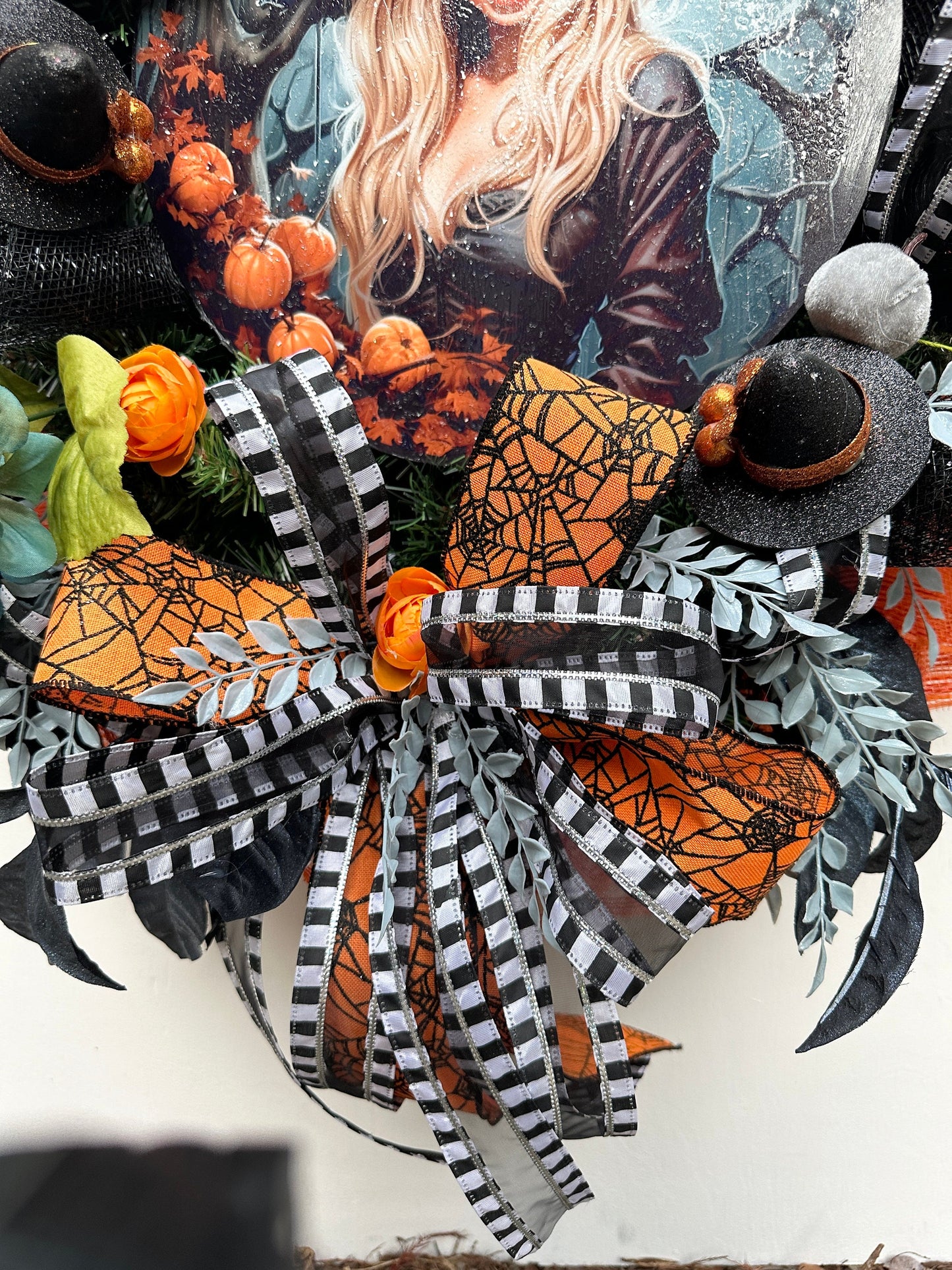 Wreath with glam witch sign, pumpkins, spider, witch hats and blue leaves gives a dark and moody Halloween vibe and add magic to your door.