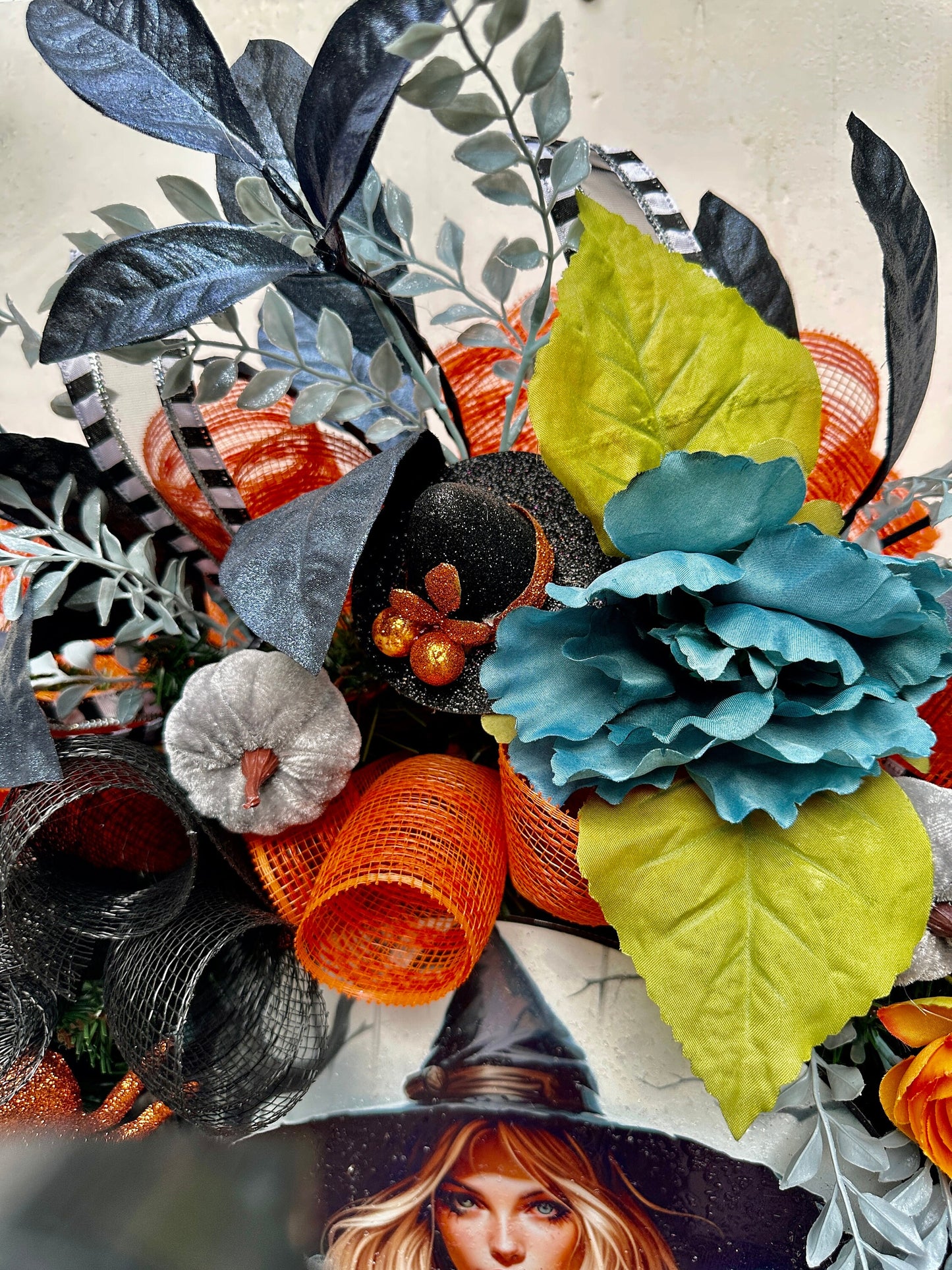 Wreath with glam witch sign, pumpkins, spider, witch hats and blue leaves gives a dark and moody Halloween vibe and add magic to your door.