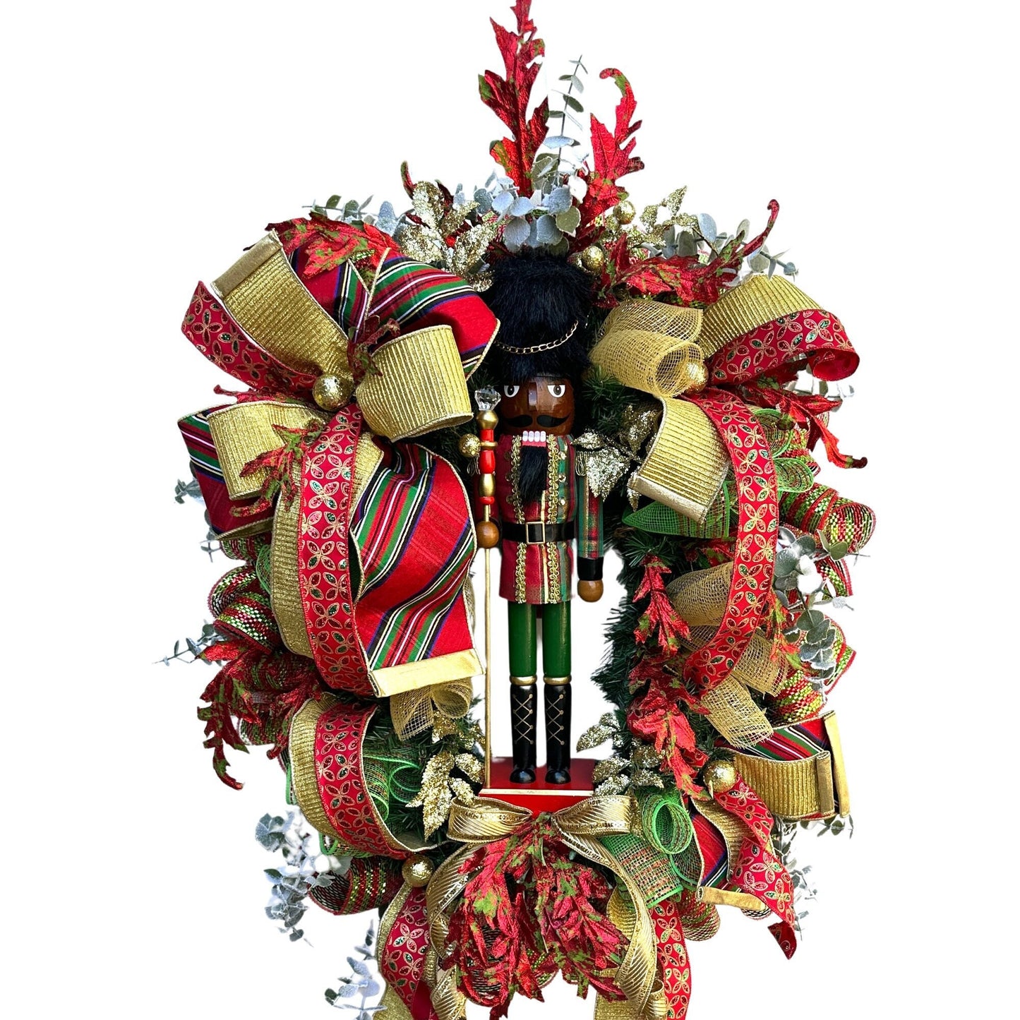 Christmas nutcracker red, green and gold nutcracker wreath features a dark face nutcracker soldier and a designer bow of 3 colorful ribbons.