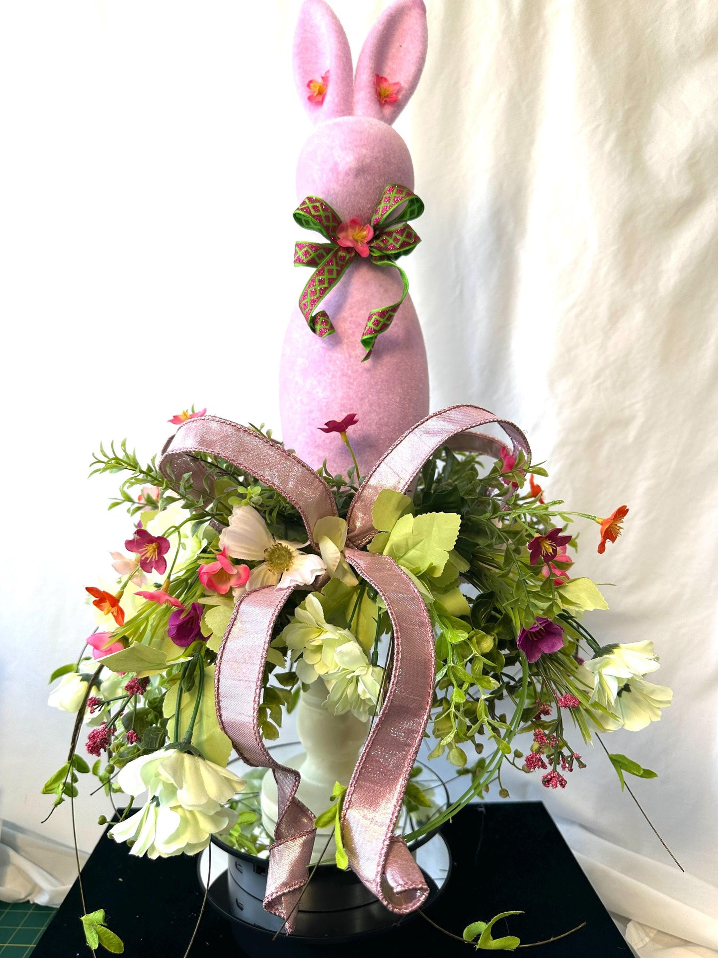 Elevate your Easter Home Decor with this enchanting Flocked Bunny Candlestick Centerpiece on a surrounded by Ribbon and Wispy Flowers.