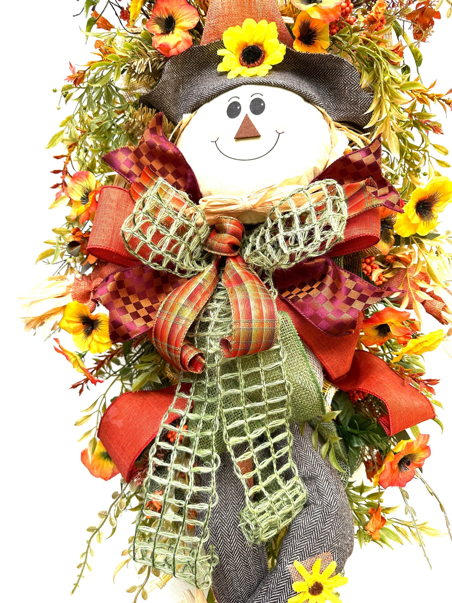 A Fall Large Smiling Scarecrow Wreath with Autumn Foliage and Festive Ribbons is the perfect Harvest, Thanksgiving or Halloween Decor