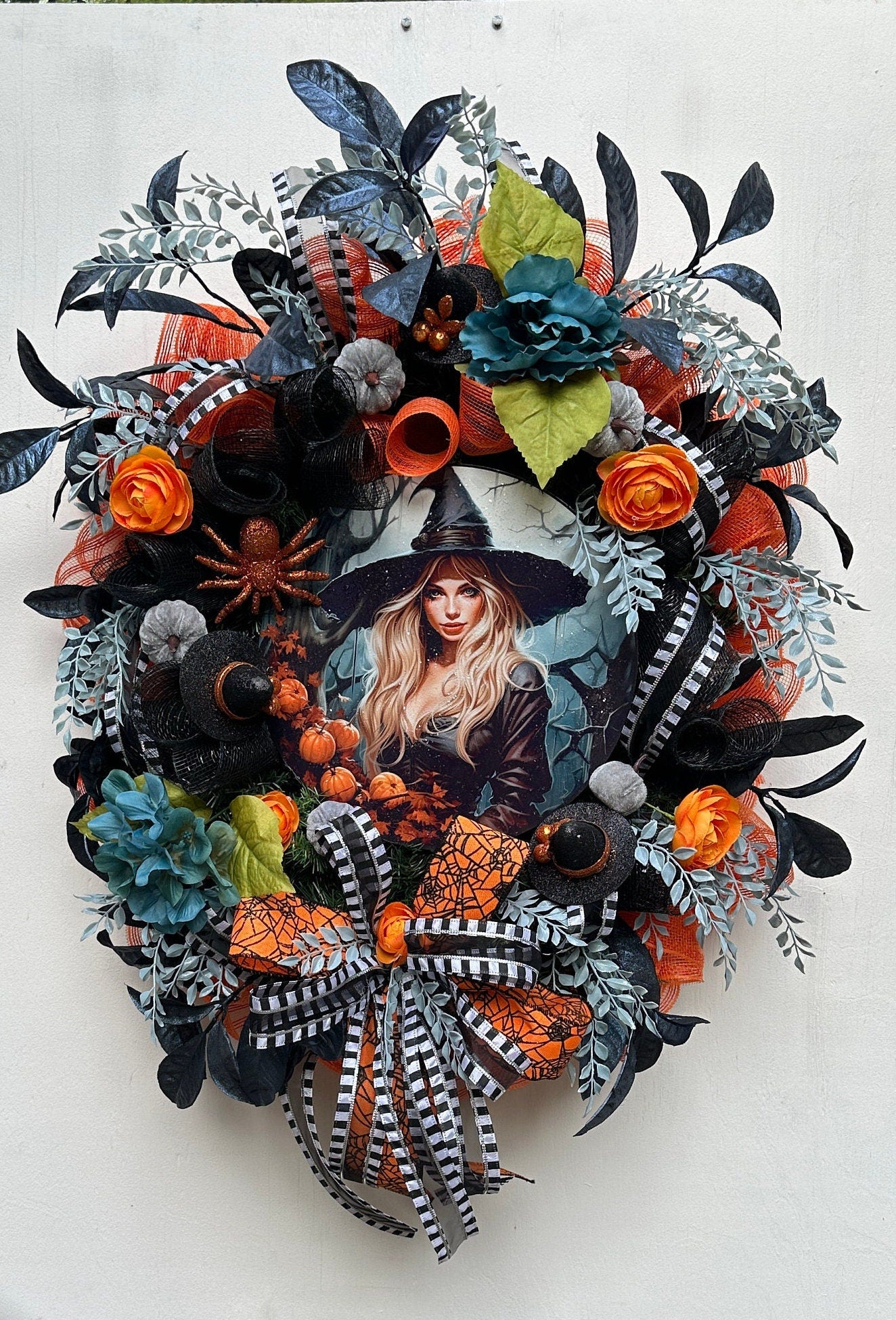 Wreath with glam witch sign, pumpkins, spider, witch hats and blue leaves gives a dark and moody Halloween vibe and add magic to your door.