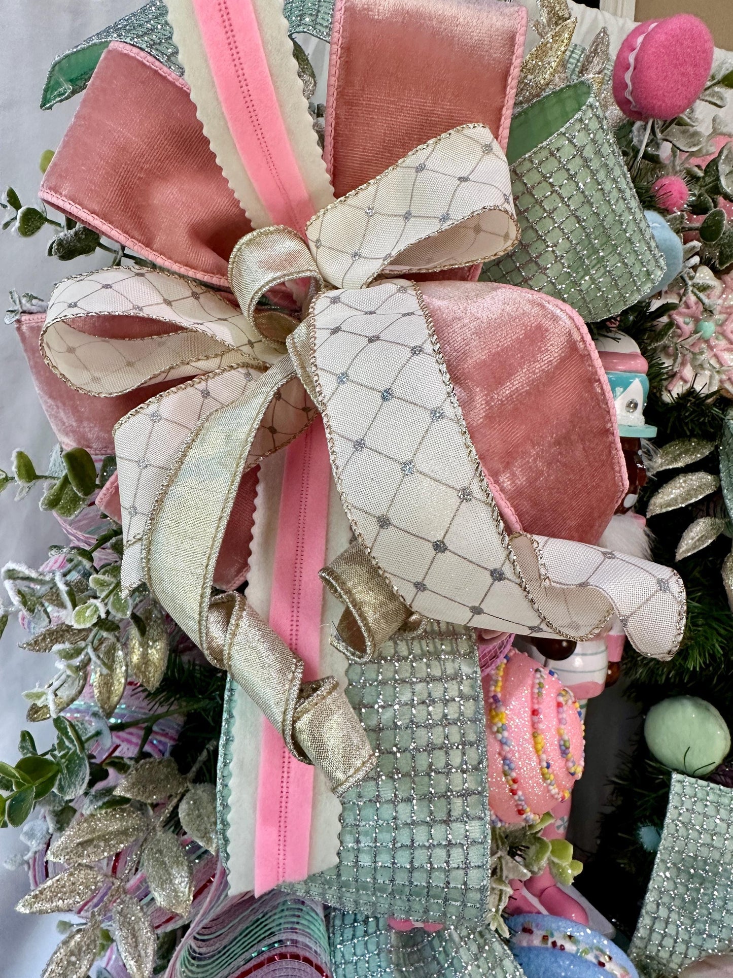 Candyland themed pink and mint green nutcracker Christmas wreath in pastel colors with dark face or light face soldier and sweet treats