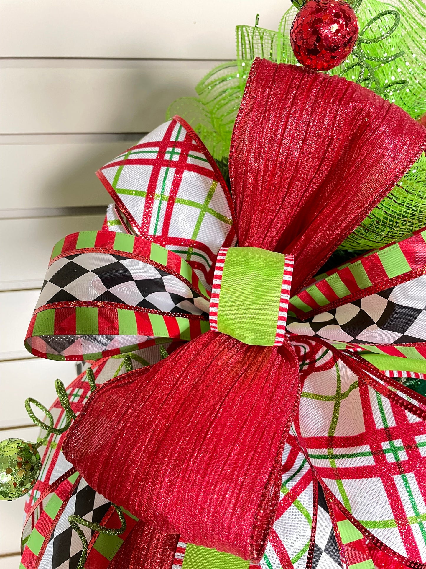 Whimsical Red and Green Christmas elf wreath perfect for front door, porch door, gift or juvenile with 4 ribbon bow with harlequin accents.