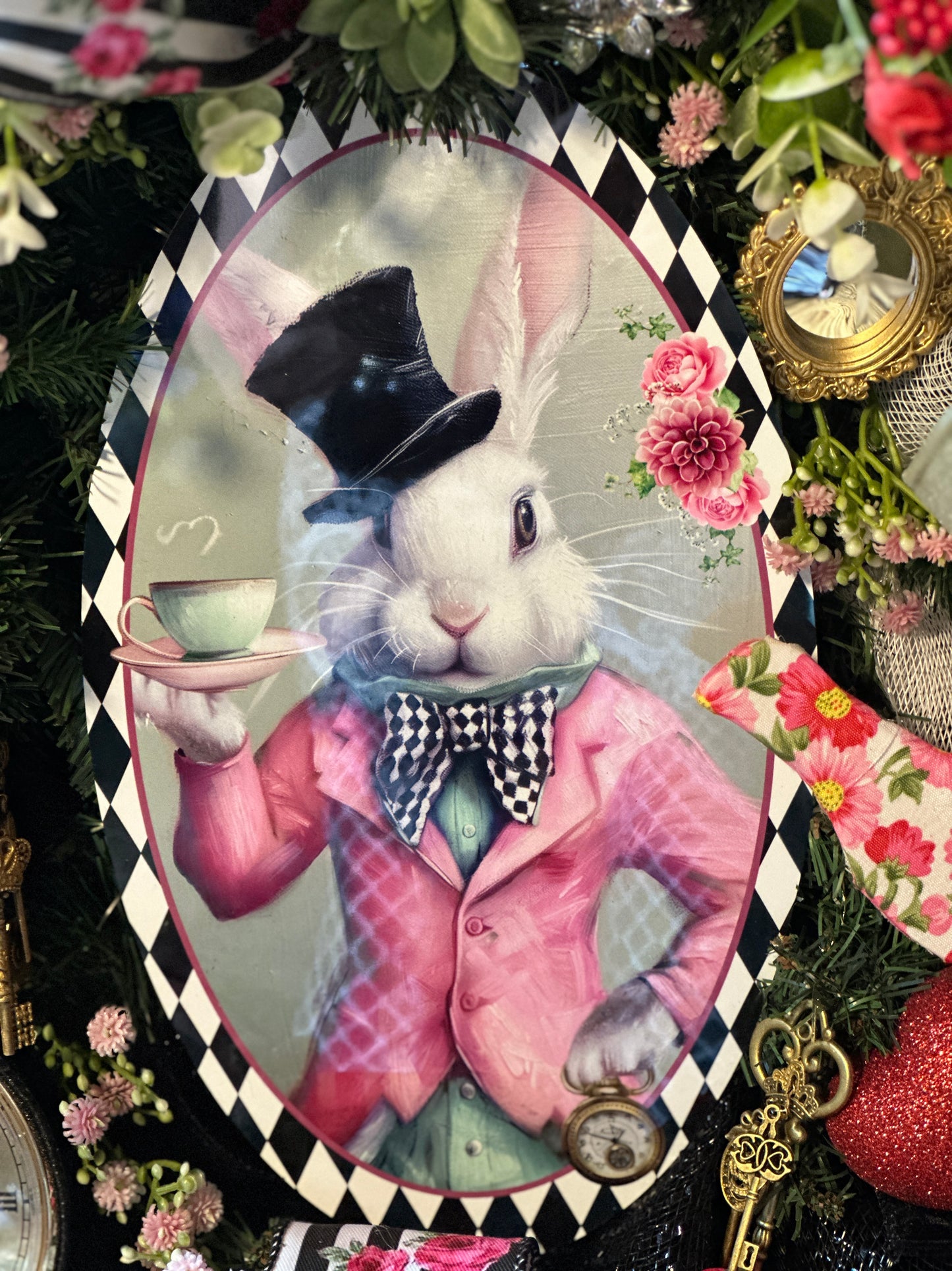 Decorative image of a rabbit in a suit holding a tea cup, surrounded by flowers and decorative elements.