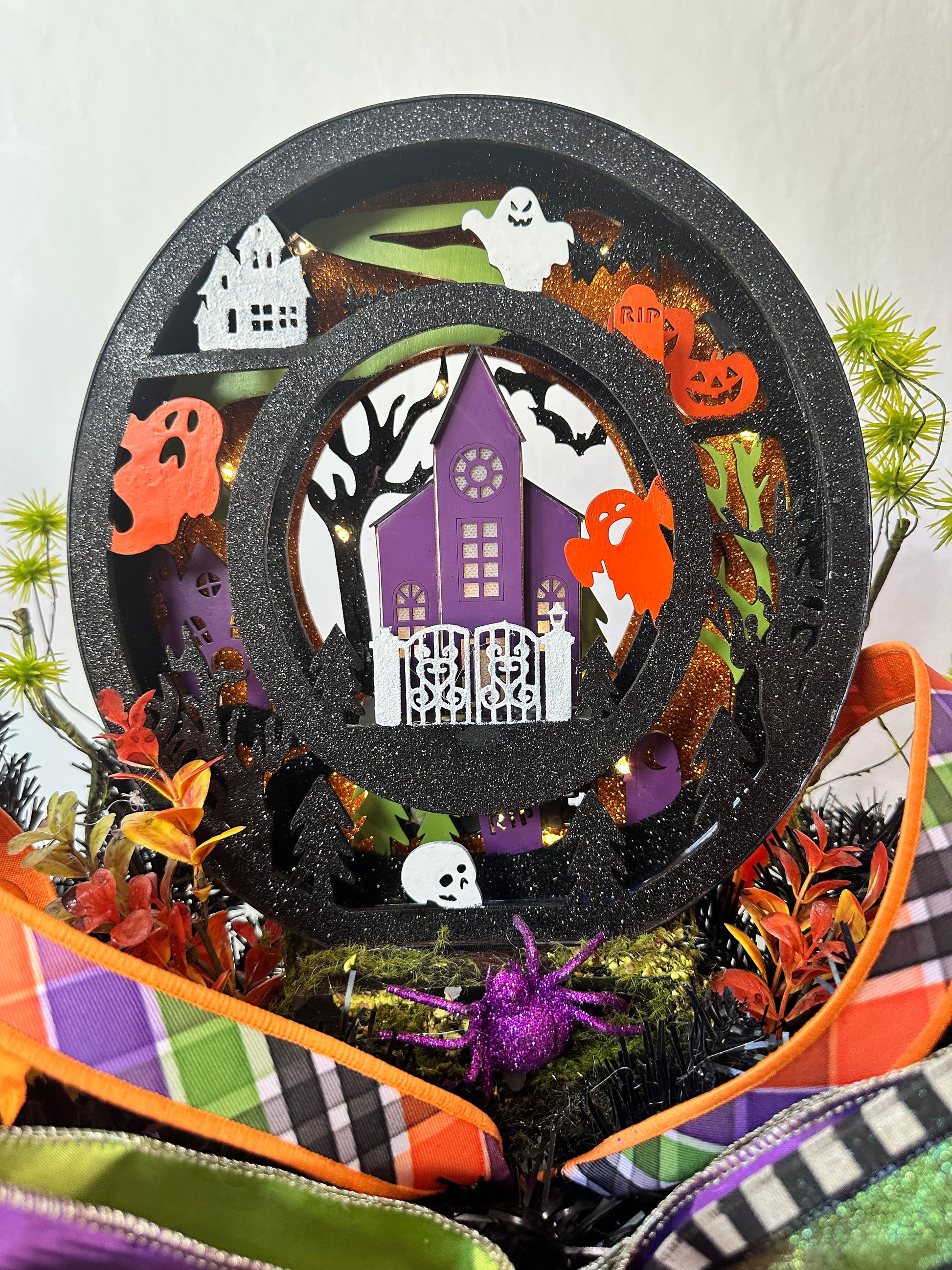 Decorative Halloween-themed ribbon with pumpkins, ghosts, and a haunted house design.