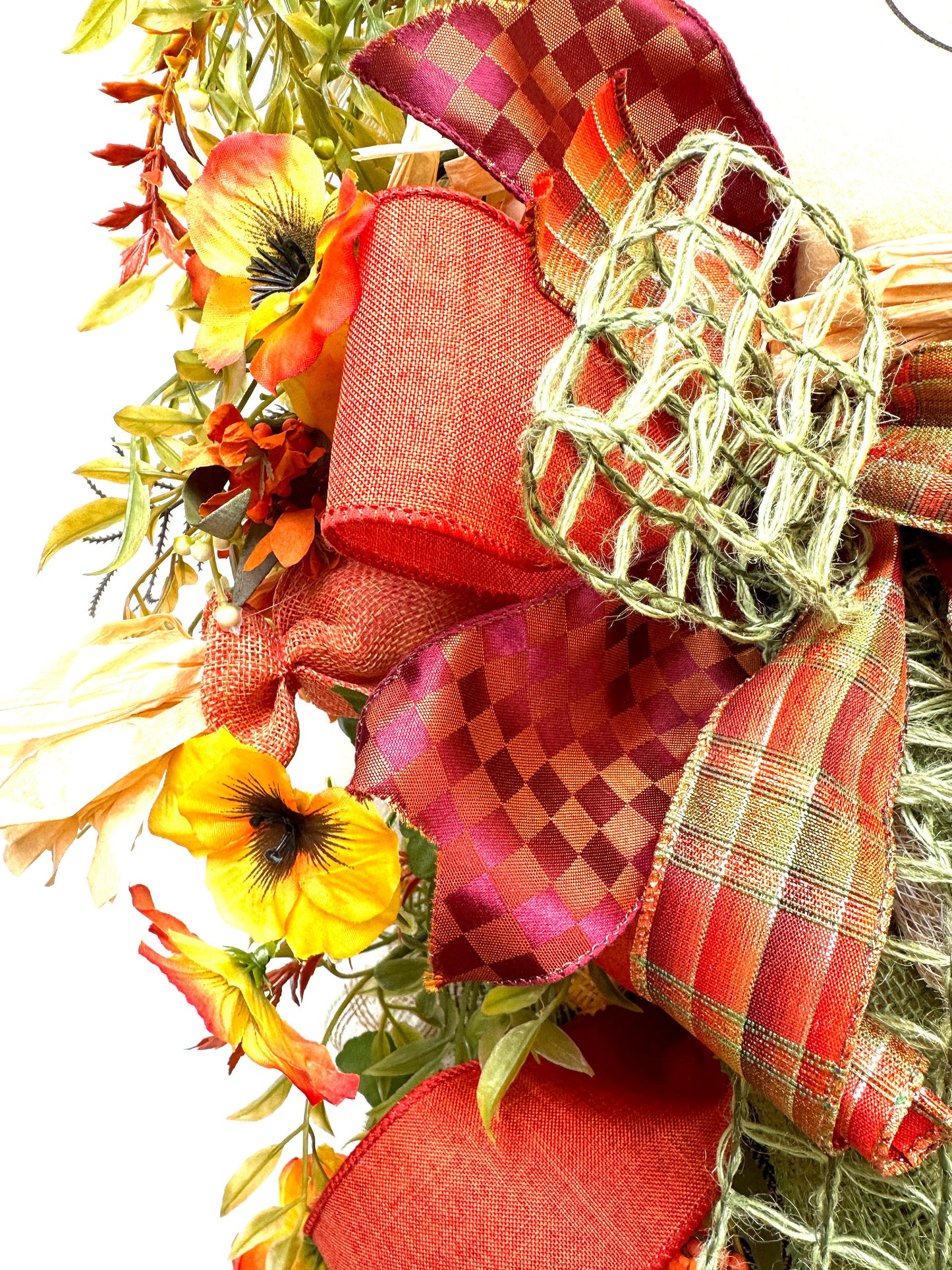 A Fall Large Smiling Scarecrow Wreath with Autumn Foliage and Festive Ribbons is the perfect Harvest, Thanksgiving or Halloween Decor
